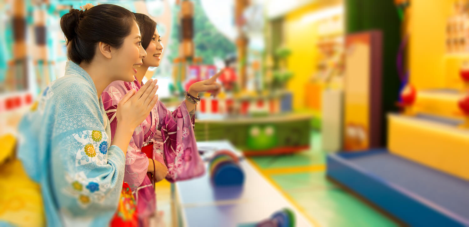 Japanese women dressed in traditional kimono are playing Daruma in a market in Tokyo, Japan.